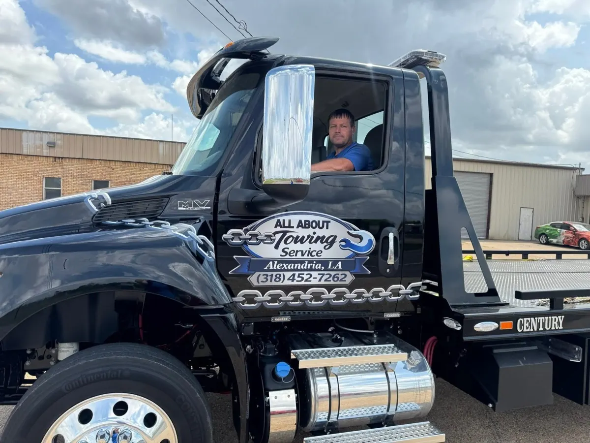 All About Towing operator in a branded tow truck, Alexandria LA